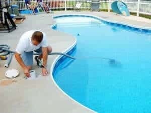a man cleeaning his pool